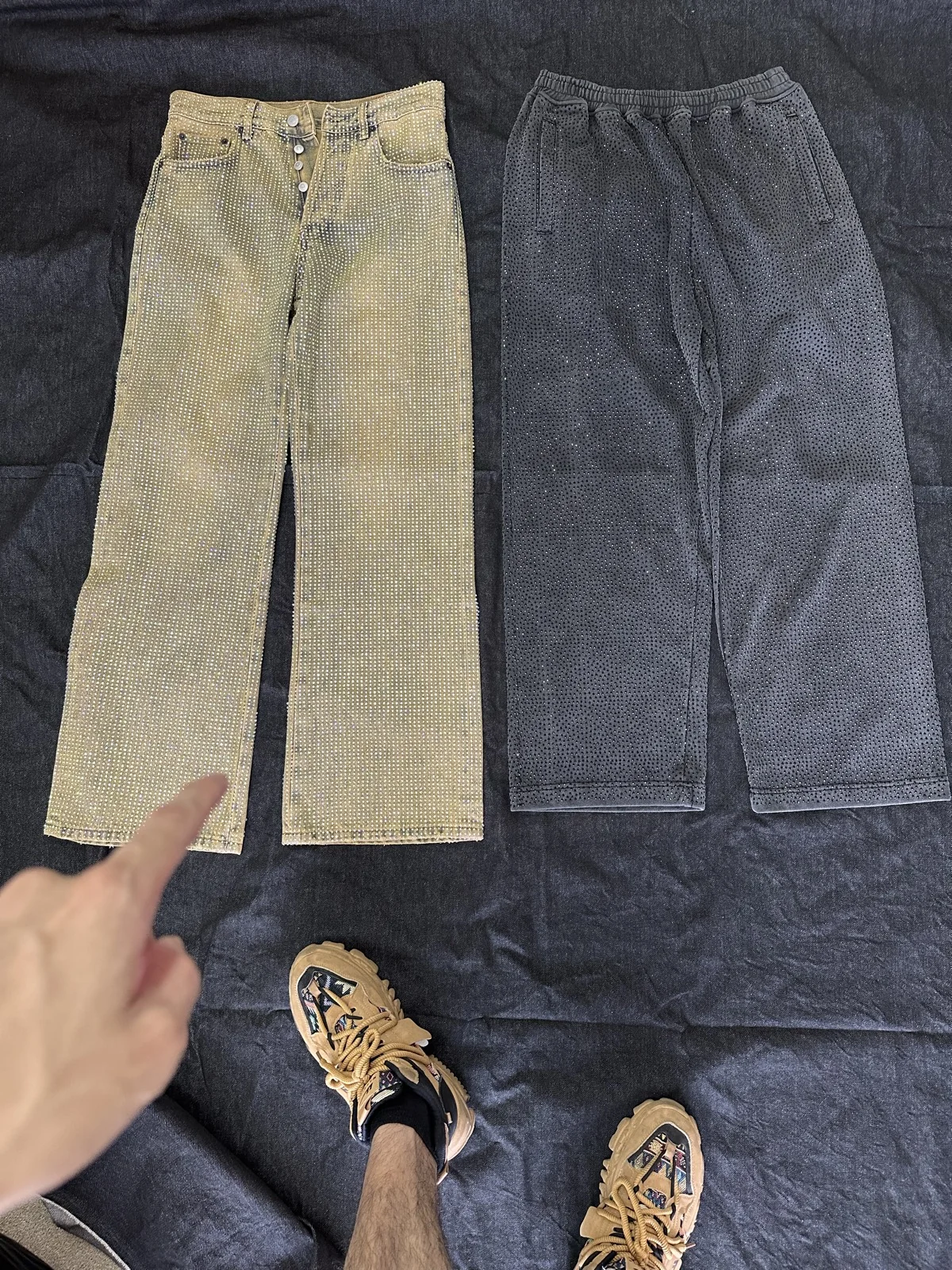 Two photographed trousers in warm beige and washed dark grey.