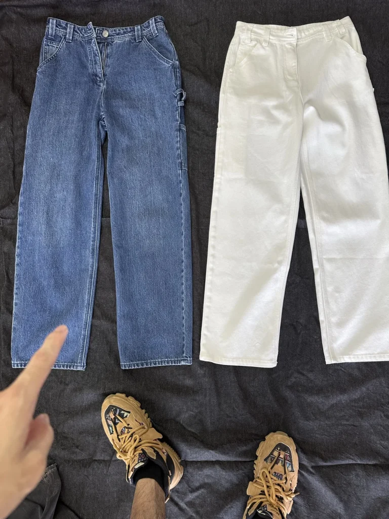 Two photographed trousers in indigo and off-white.