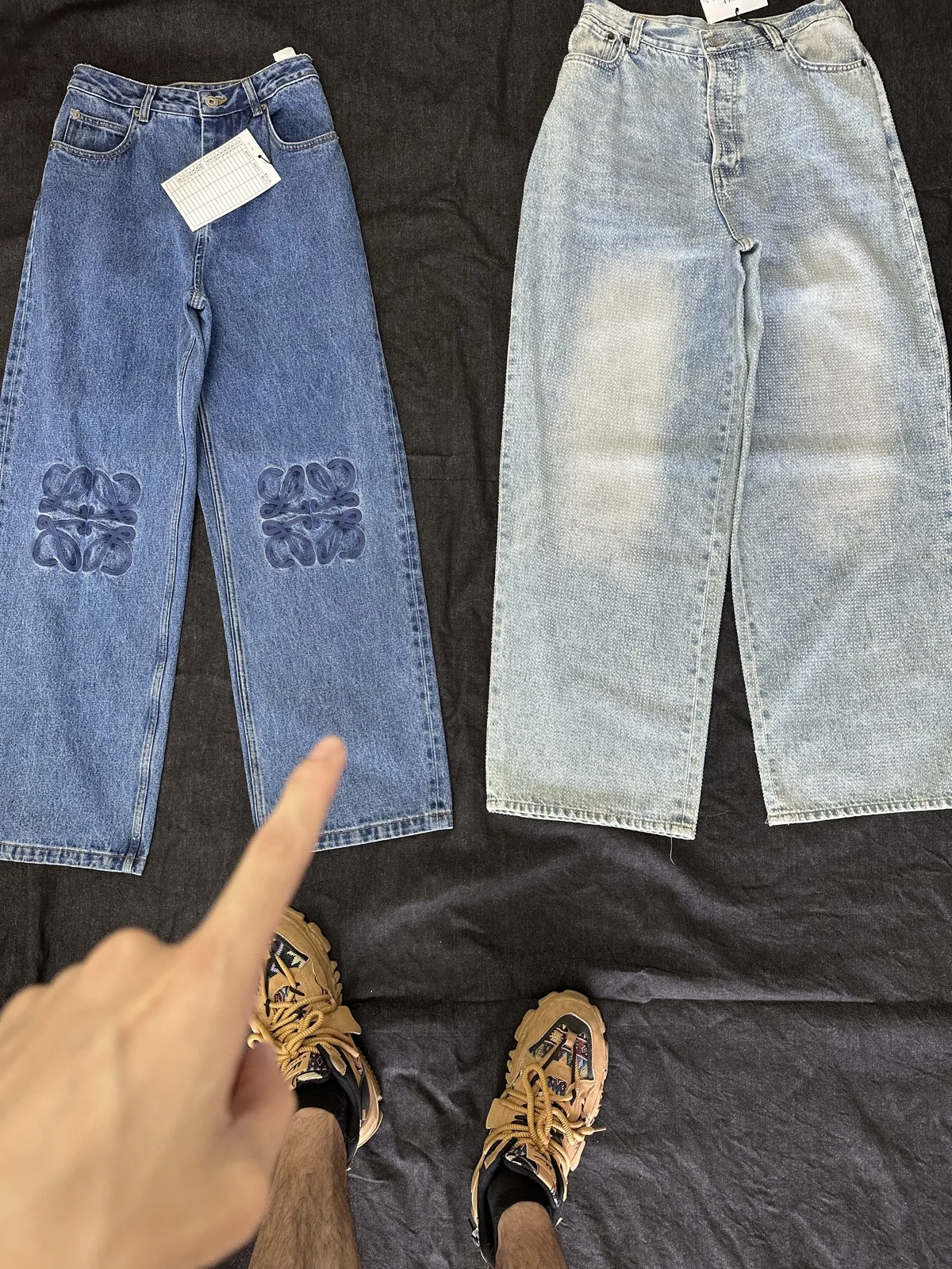 Indigo and light-wash trousers with contrasting surface details.