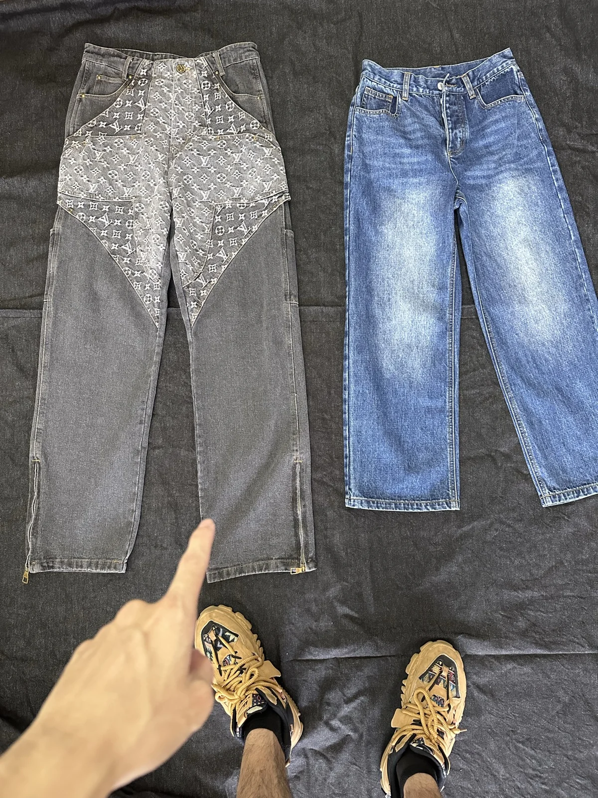Grey and indigo trousers showing contrasting panels and surface details.