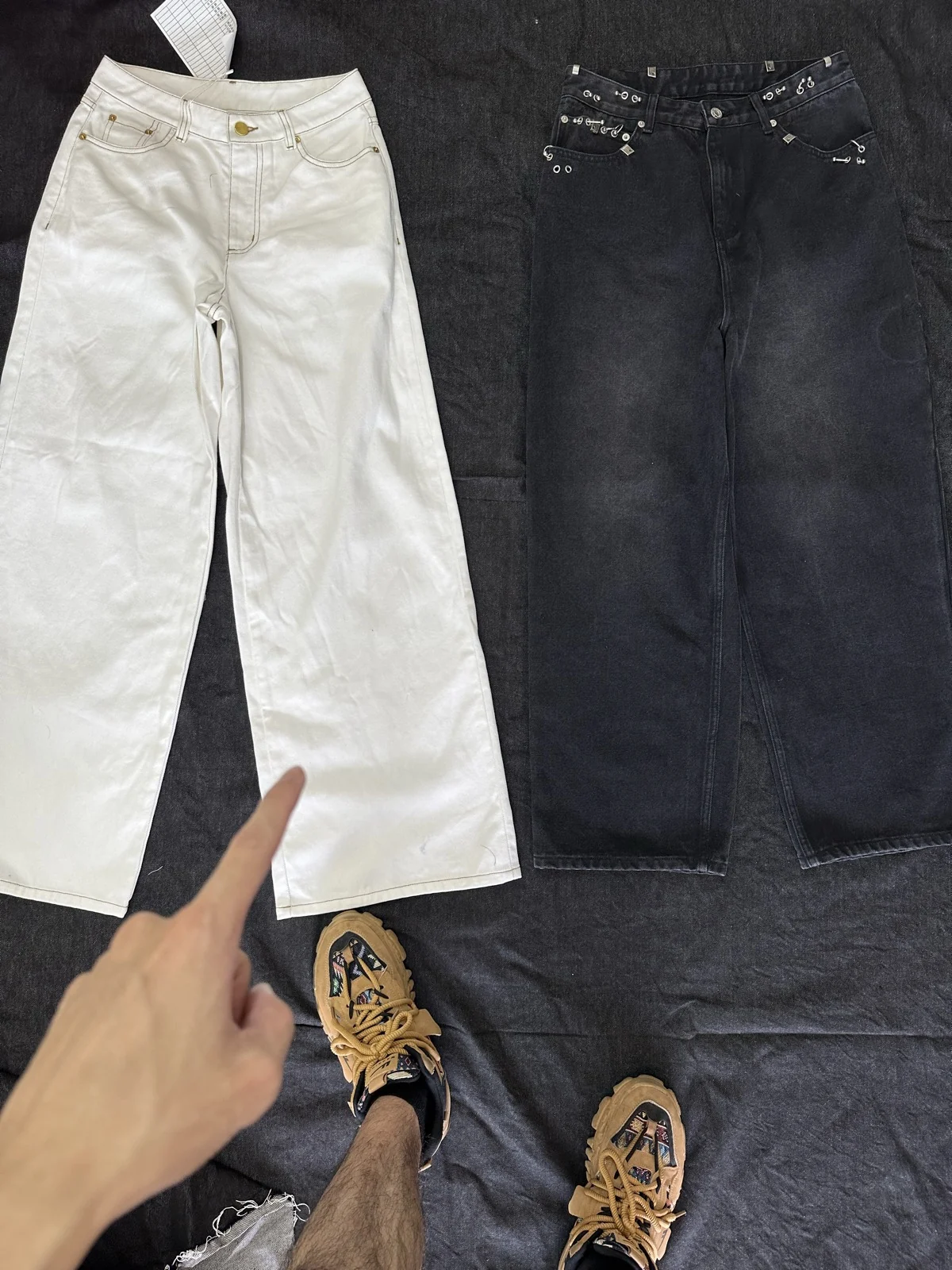 Off-white and dark trousers photographed side by side.