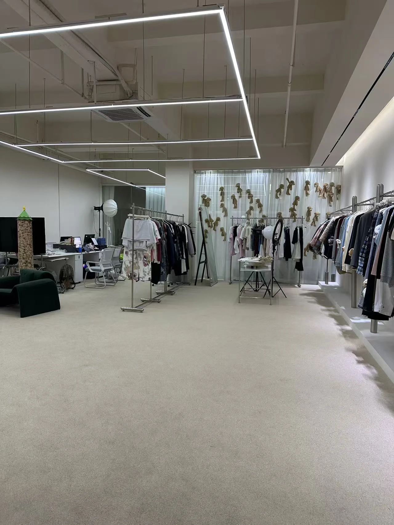Seasang showroom with clothing rails, garment displays and linear ceiling lights